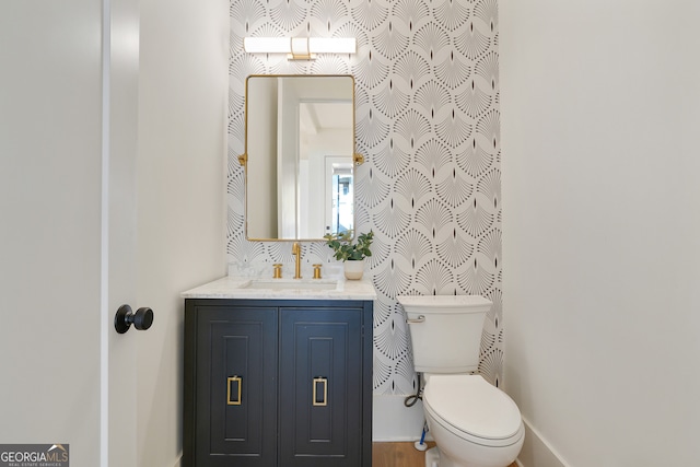 bathroom featuring vanity and toilet