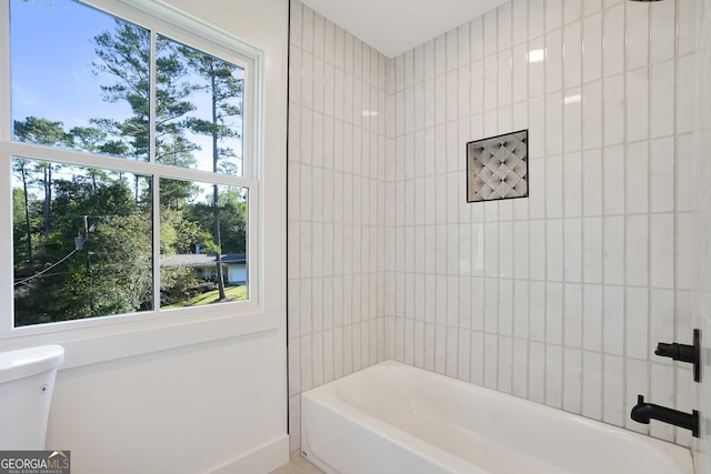 bathroom with shower / bathing tub combination and a wealth of natural light