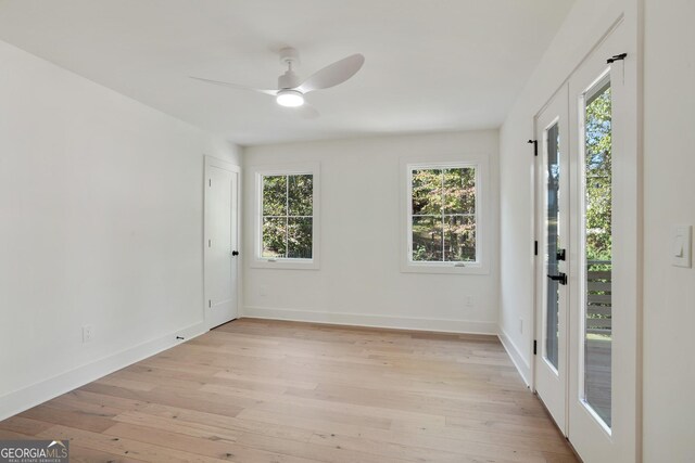 empty room featuring light hardwood / wood-style flooring and ceiling fan