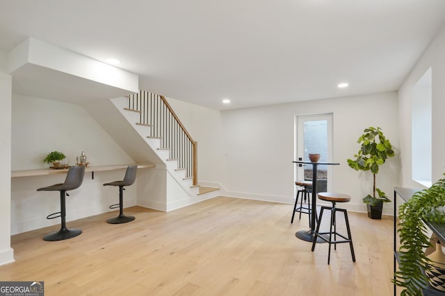 interior space with recessed lighting, stairway, baseboards, and light wood-style floors