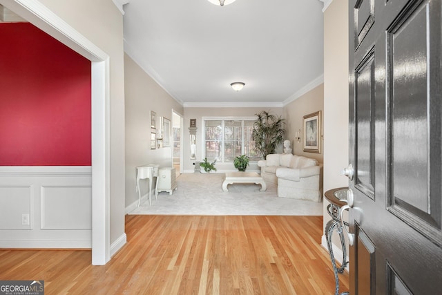 foyer entrance with hardwood / wood-style floors and ornamental molding