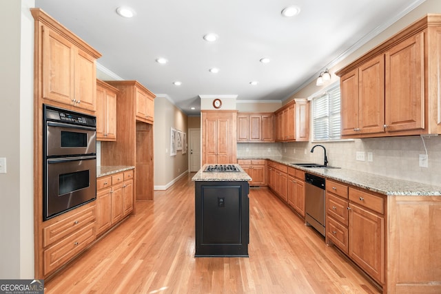 kitchen with light stone countertops, light wood-type flooring, stainless steel appliances, and a kitchen island