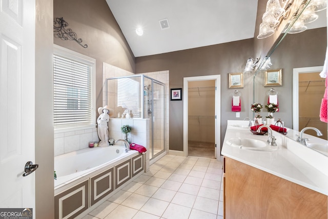 bathroom with tile patterned floors, vanity, independent shower and bath, and vaulted ceiling