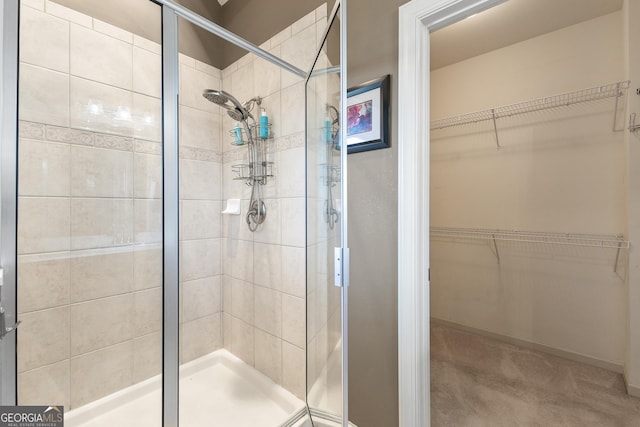 bathroom featuring a shower with shower door