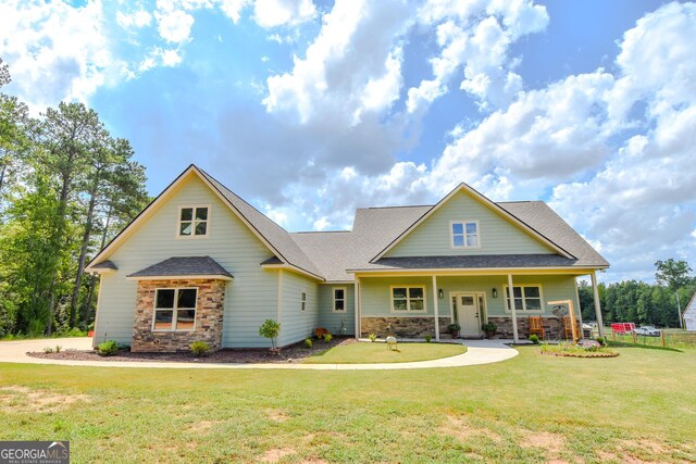 craftsman-style home with covered porch and a front lawn