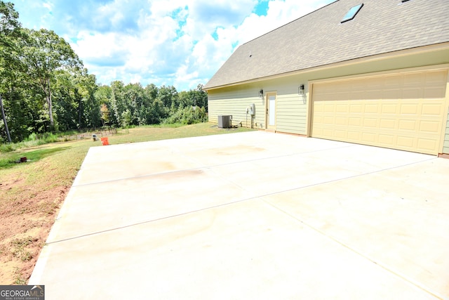 view of home's exterior featuring a garage and central air condition unit