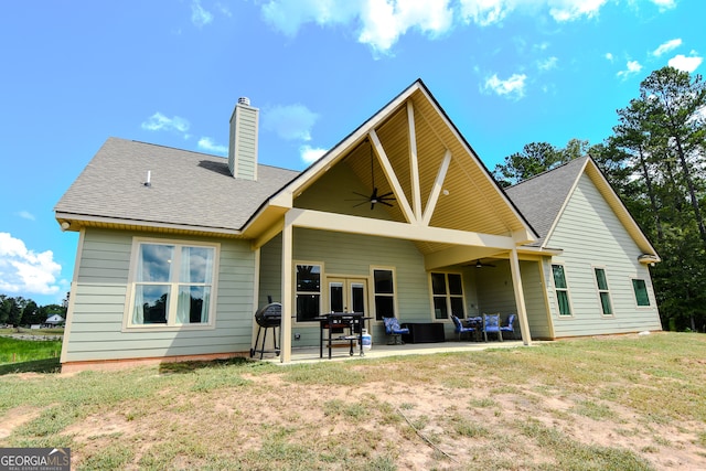 rear view of property featuring ceiling fan, a patio, and an outdoor living space