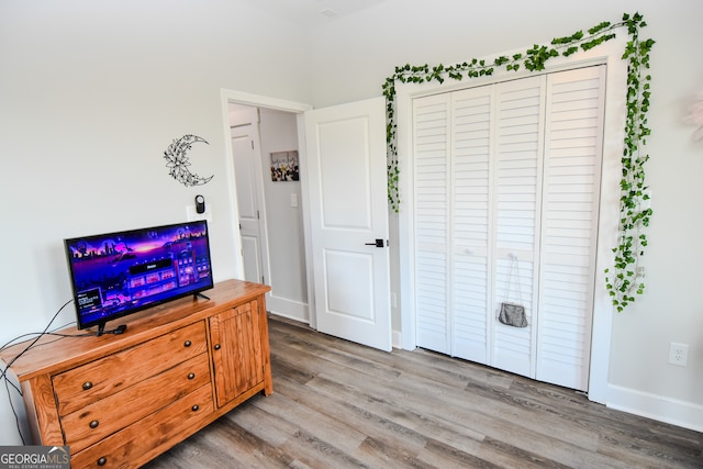 bedroom with a closet and hardwood / wood-style flooring