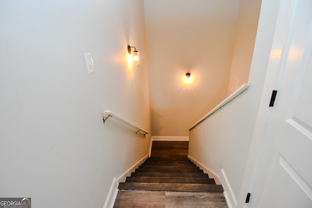 staircase with hardwood / wood-style floors