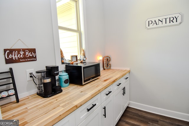 office with plenty of natural light and dark hardwood / wood-style floors