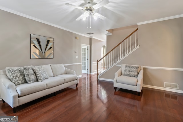 living room featuring crown molding, ceiling fan, and dark hardwood / wood-style flooring