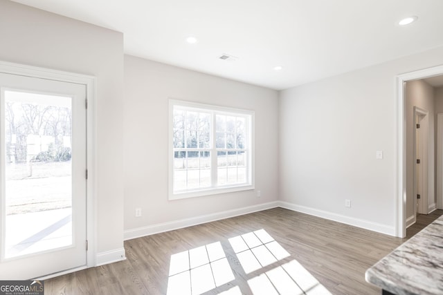 interior space with light wood-type flooring, visible vents, baseboards, and recessed lighting