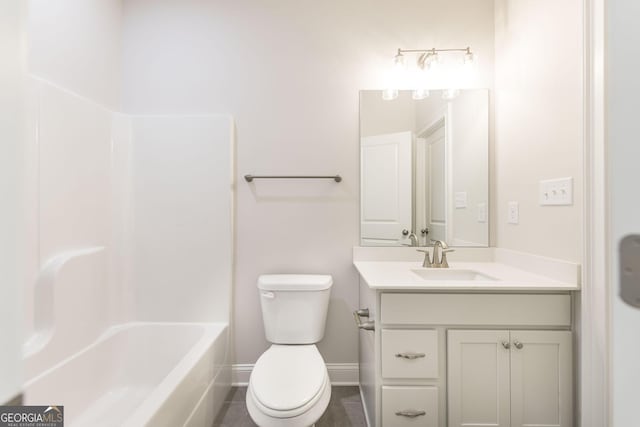 bathroom featuring toilet, tile patterned floors, baseboards, and vanity