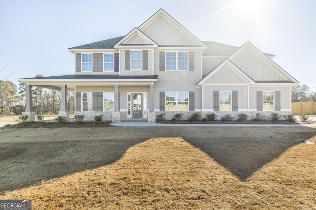 view of front of house featuring board and batten siding and roof with shingles