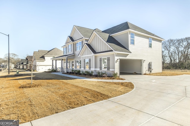 craftsman-style home with driveway, board and batten siding, an attached garage, and roof with shingles