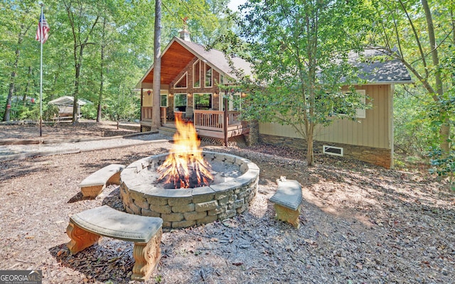 view of yard with a fire pit and a deck