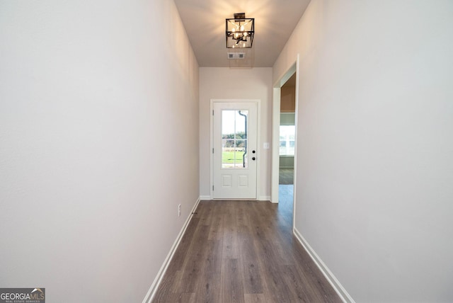 doorway to outside featuring hardwood / wood-style flooring and a chandelier