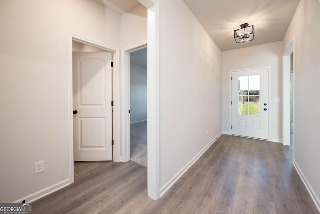 entryway featuring an inviting chandelier and hardwood / wood-style flooring