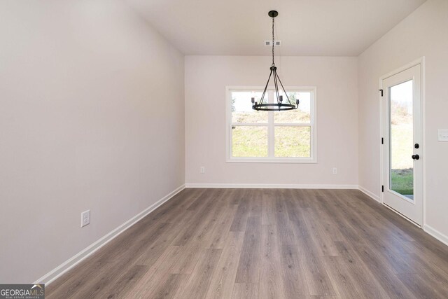 unfurnished dining area featuring dark hardwood / wood-style floors