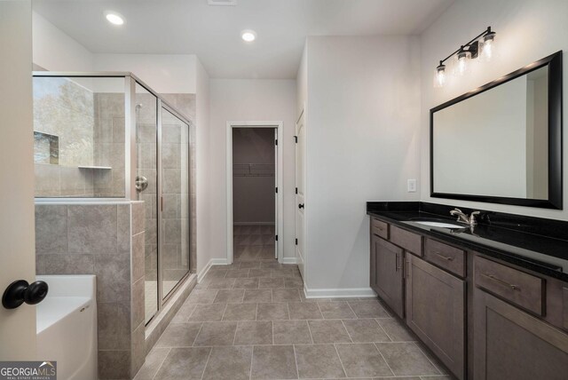 bathroom featuring separate shower and tub, tile patterned floors, and vanity