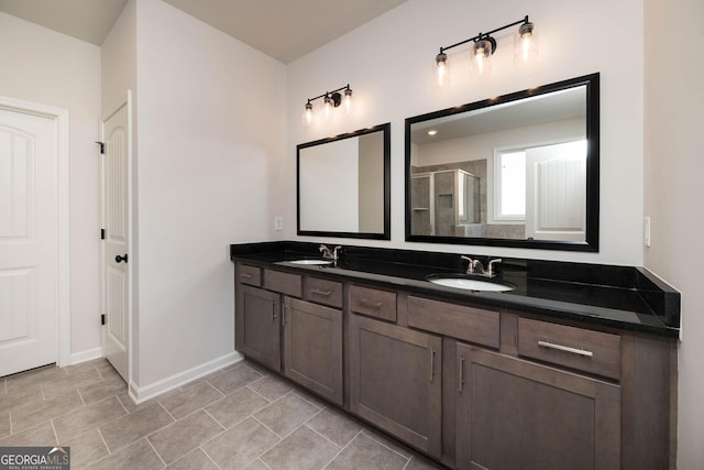 bathroom featuring tile patterned flooring, vanity, and walk in shower