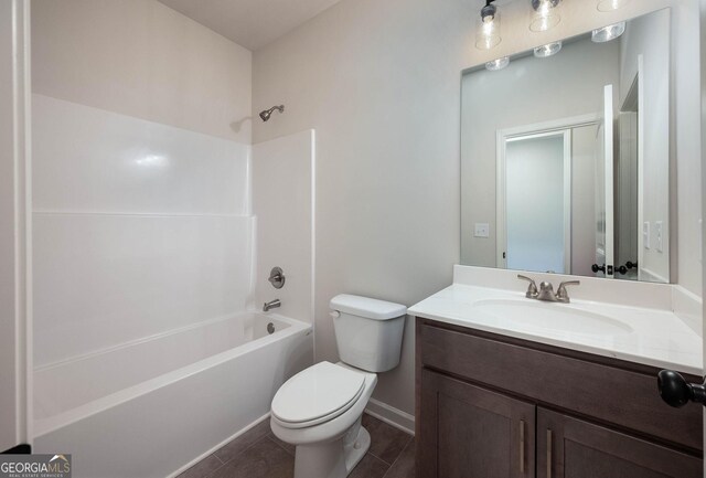 full bathroom with tile patterned flooring, vanity, shower / bathtub combination, and toilet