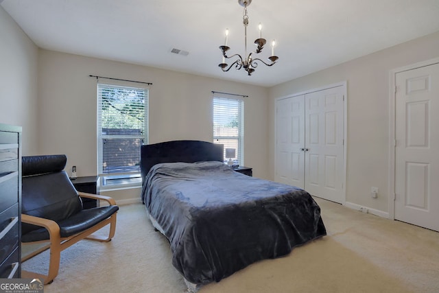 carpeted bedroom featuring an inviting chandelier and a closet