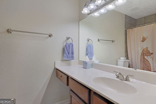 bathroom with a shower with curtain, vanity, and toilet