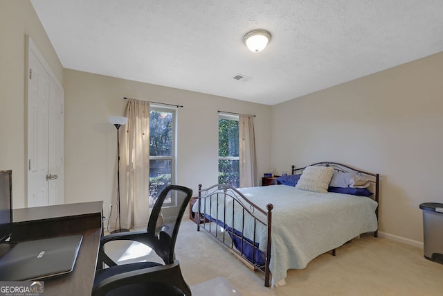 carpeted bedroom with a textured ceiling