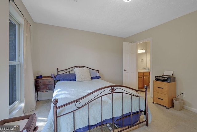 carpeted bedroom featuring ensuite bathroom