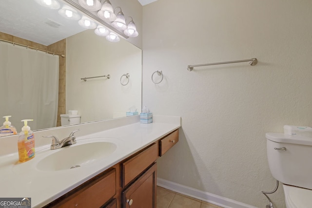 bathroom featuring walk in shower, vanity, toilet, and tile patterned floors