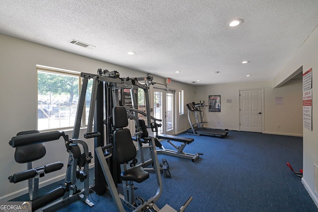 gym featuring a textured ceiling