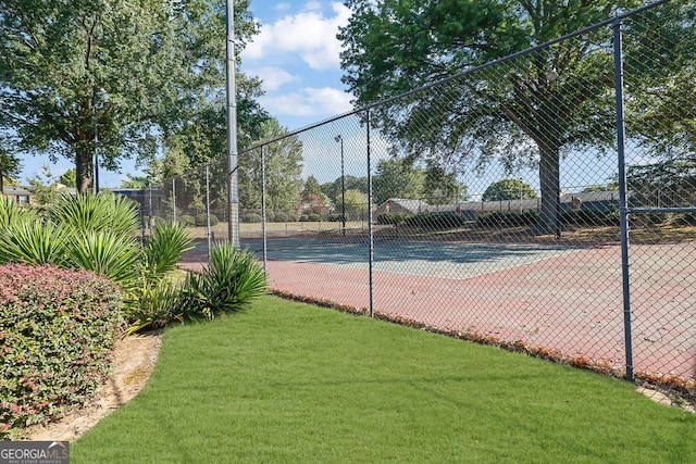 view of sport court featuring a yard