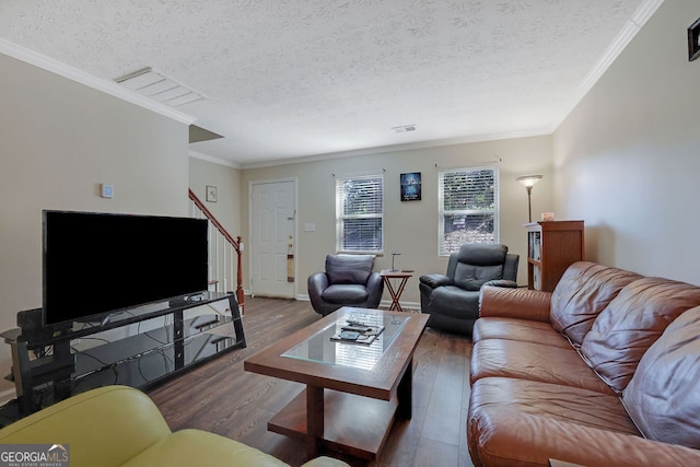 living room featuring ornamental molding, a textured ceiling, and dark hardwood / wood-style flooring