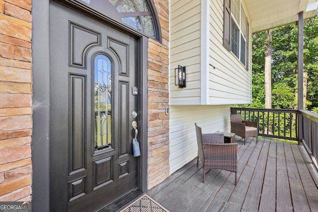 view of exterior entry featuring a porch