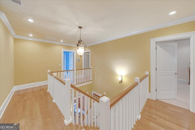 corridor featuring light hardwood / wood-style flooring and ornamental molding