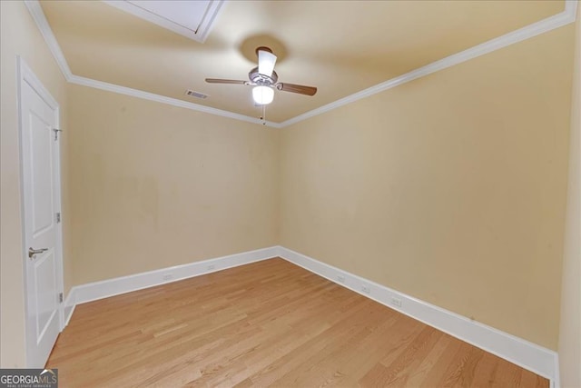 empty room with ceiling fan, hardwood / wood-style flooring, and crown molding