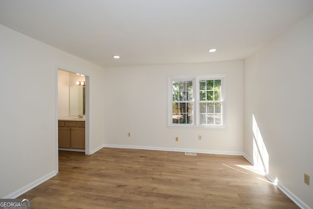 spare room with light hardwood / wood-style flooring and sink