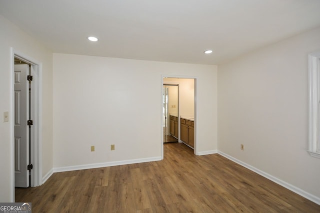 unfurnished room featuring hardwood / wood-style flooring