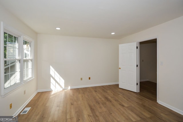 spare room with hardwood / wood-style floors