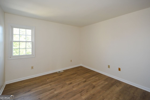 spare room with dark hardwood / wood-style flooring