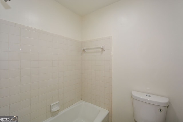 bathroom with tiled shower / bath and toilet