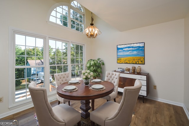 dining room featuring a wealth of natural light, dark hardwood / wood-style floors, and a notable chandelier