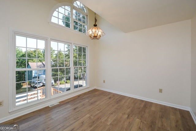 interior space with hardwood / wood-style floors and an inviting chandelier