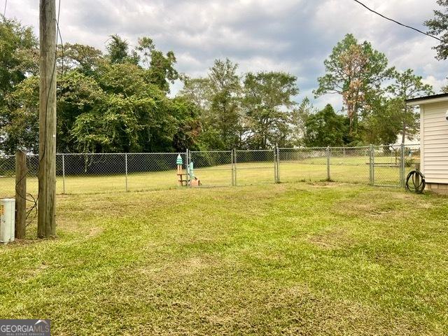 view of yard featuring a gate and fence