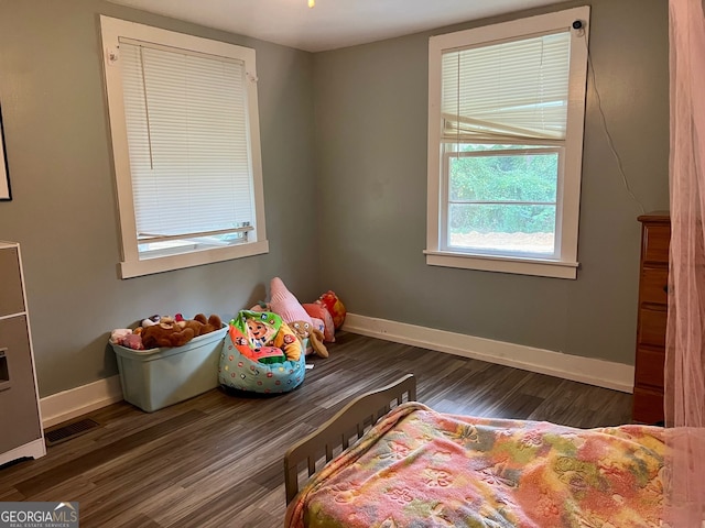 bedroom with dark wood-type flooring