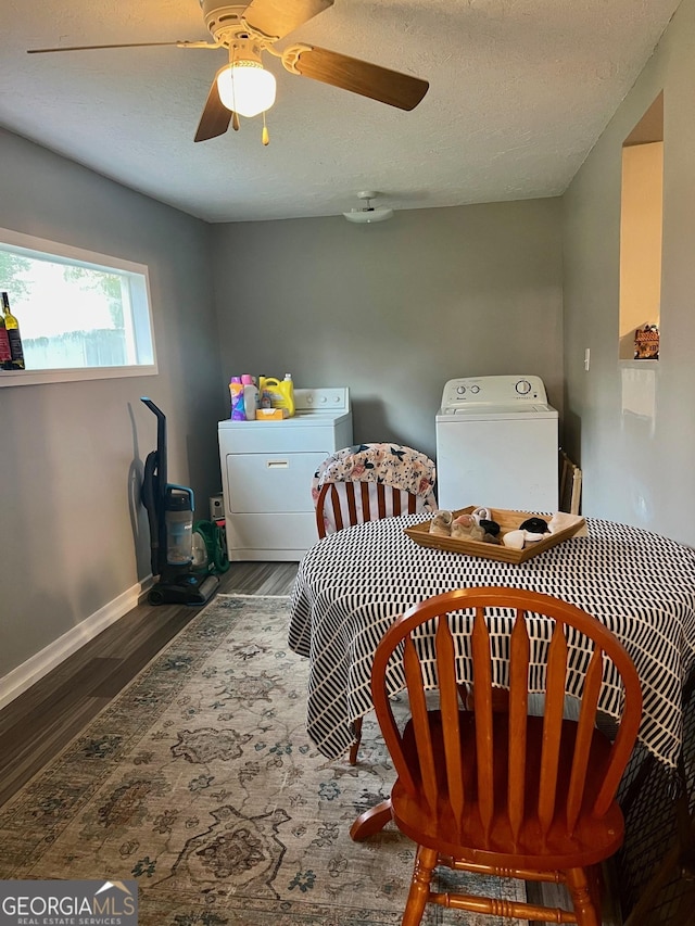 bedroom featuring ceiling fan, a textured ceiling, washing machine and dryer, wood finished floors, and baseboards