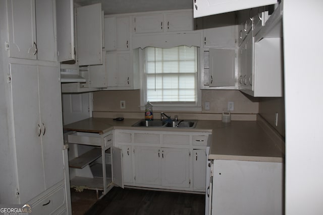 kitchen featuring dark wood-type flooring, white cabinets, and sink