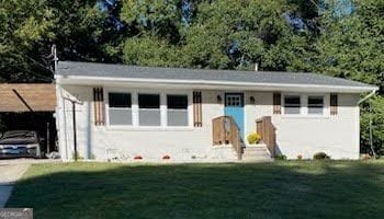 view of front of home with a garage and a front lawn