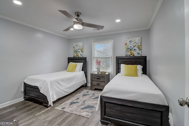 bedroom featuring ornamental molding, wood-type flooring, and ceiling fan